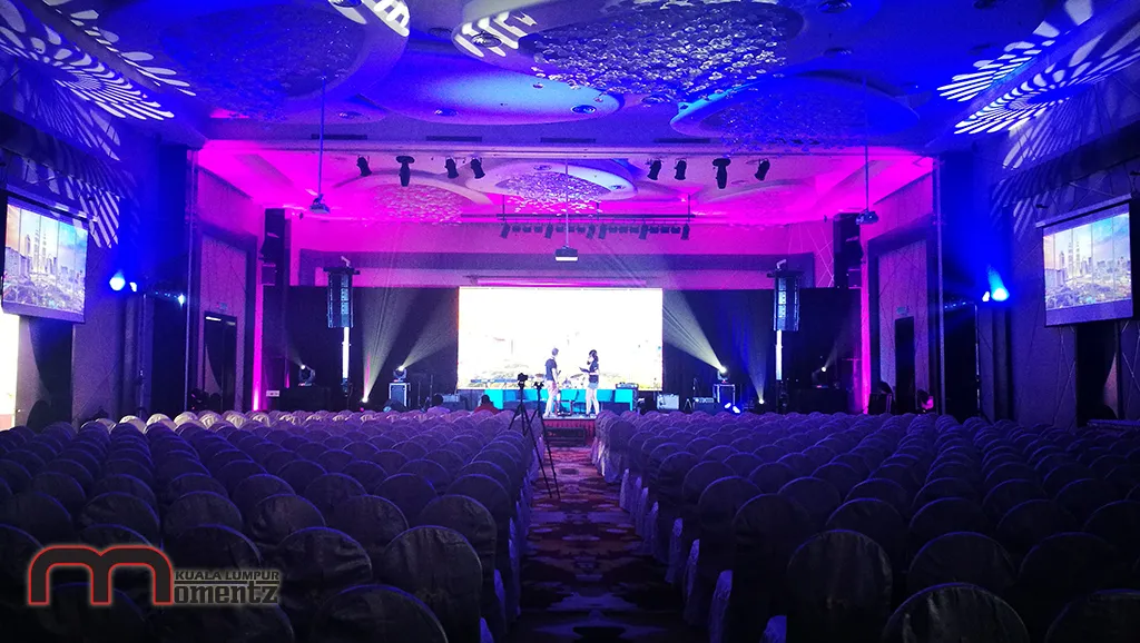 A conference ballroom in Kuala Lumpur lit in deep blue and magenta by MomentzKL